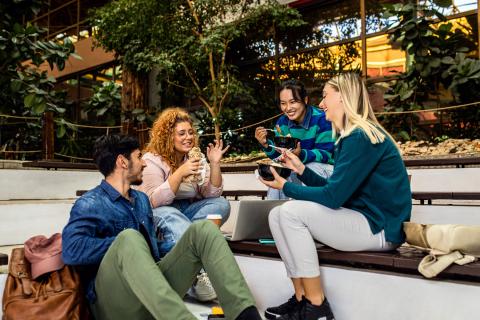 Group of student siting in campus having lunch brake.