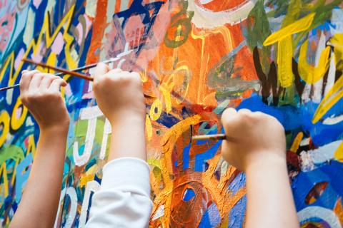 Kids hands with Colourful Paint Background
