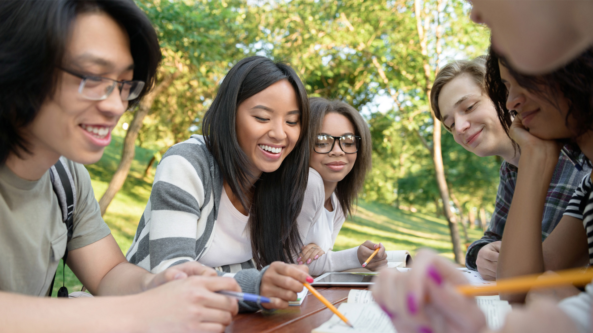Students gathered around table outside