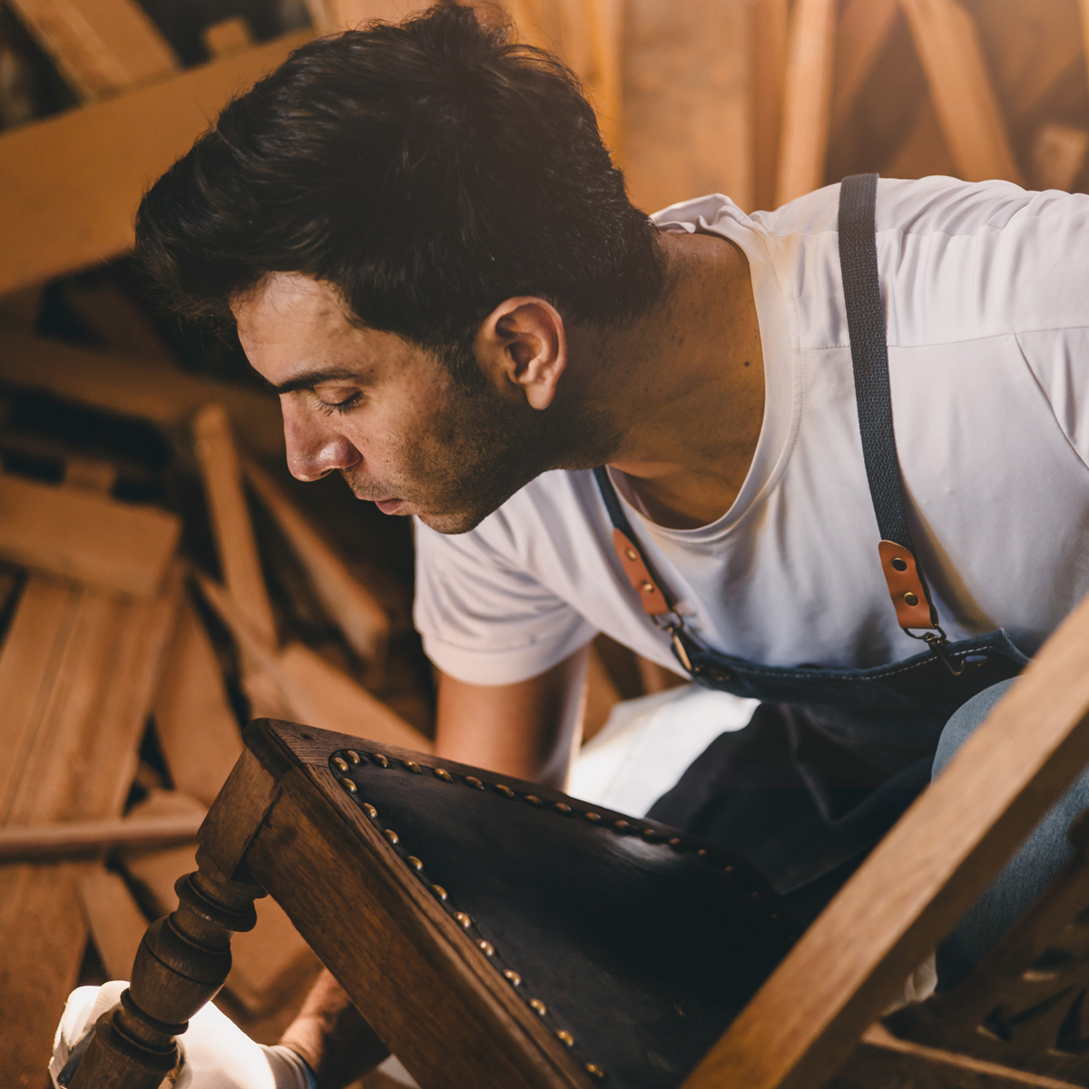 Carpenter man attend to making masterpiece woodworks handcrafted fine detail make wooden furniture in wood workshop.