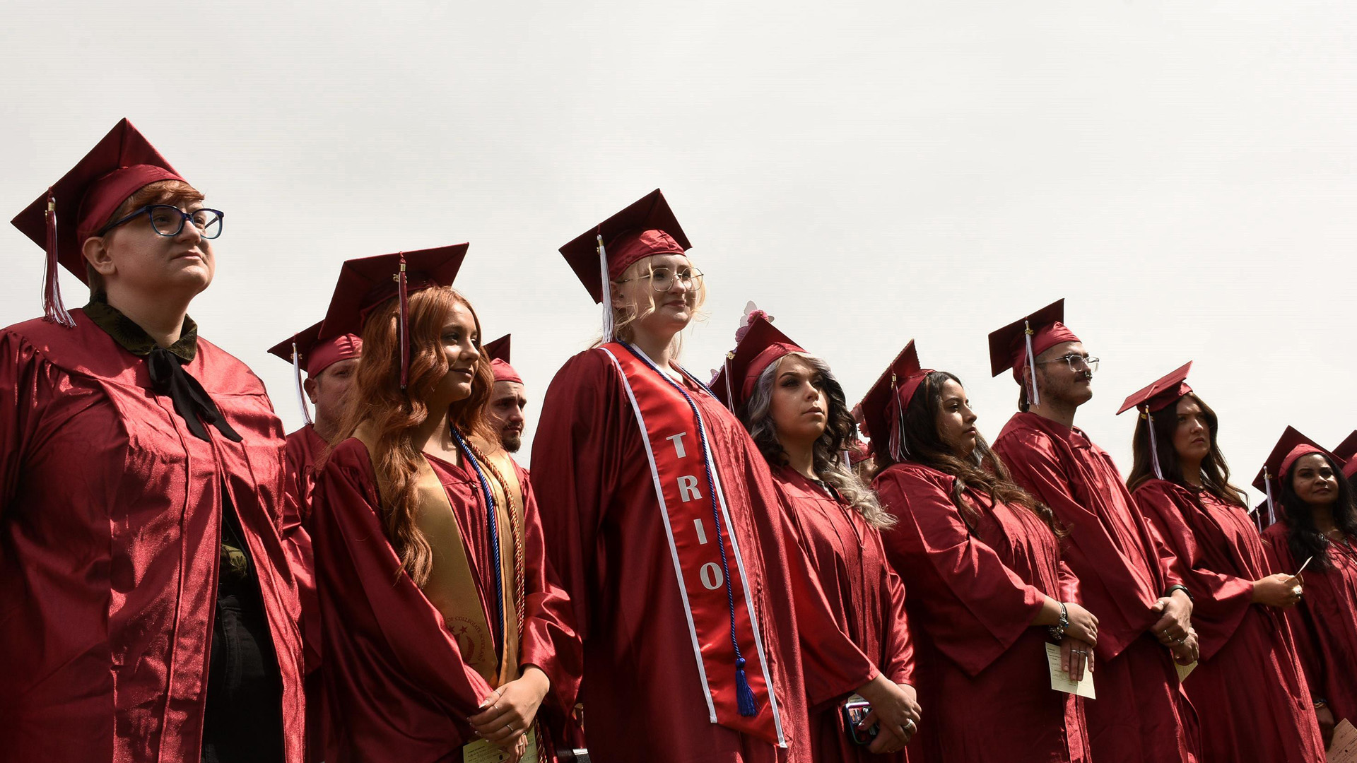 students standing outside at graduation