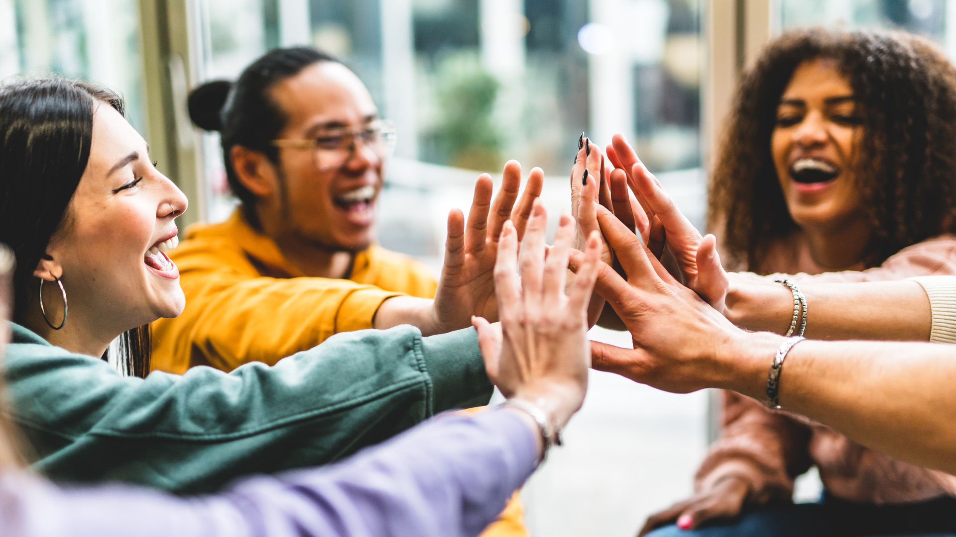 Group of people putting their hands together in a circle