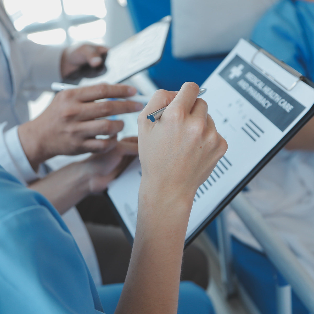 medical professionals looking at patients chart