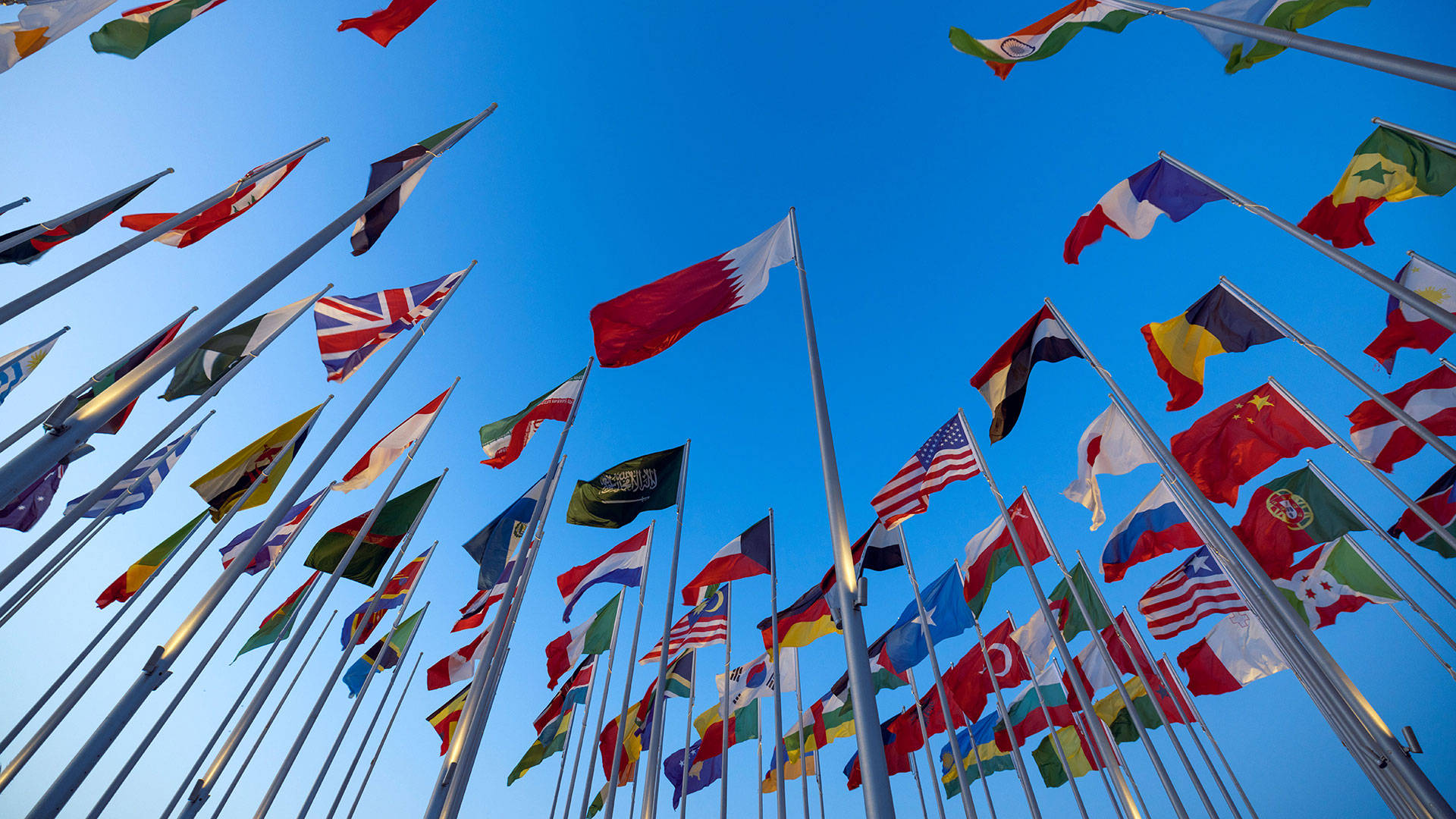 international flags with the sky behind it