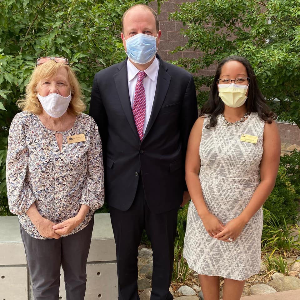 Michele Haney standing with Governer Polis
