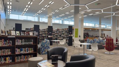 tables, chairs and bookshelves in the library
