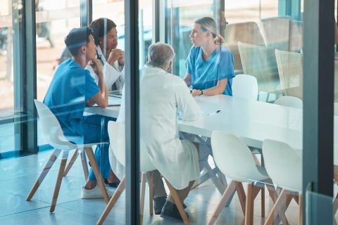 healthcare team and meeting for a discussion, planning or training at table