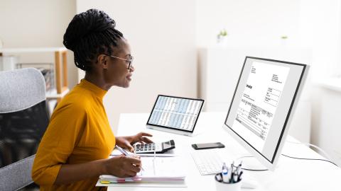 Woman working on her computer at her desk