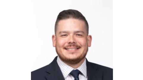 Headshot of Matt Garcia, smiling, in a suit.