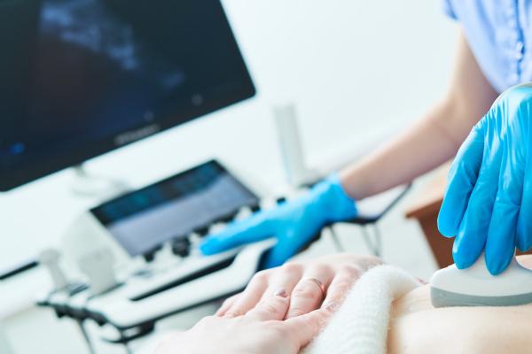 Medical ultrasound imaging and scan. Examining stomach of female patient