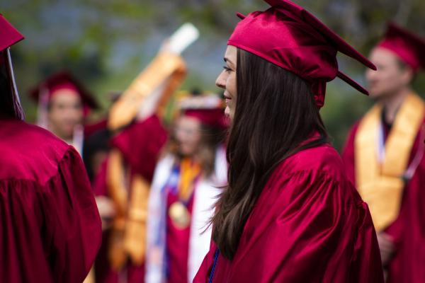 Graduates in red caps and gowns