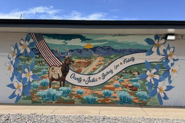 A mural with an elk, and columbine flowers.