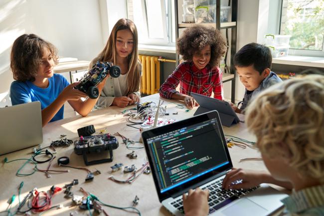 chool children students build robotic cars using computers and coding