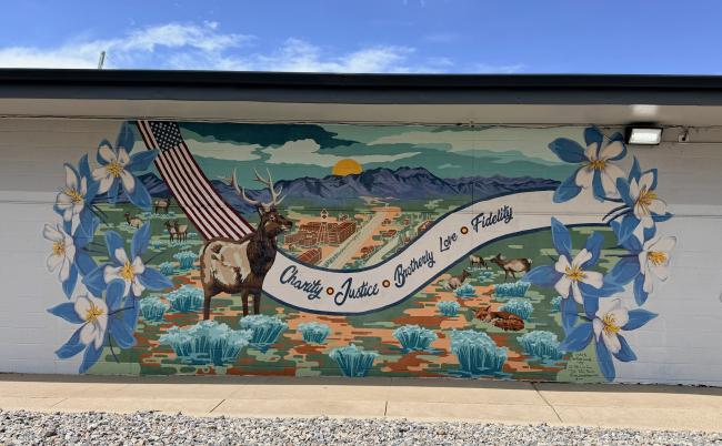 A mural with an elk, and columbine flowers.