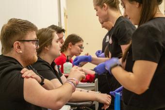 Students preparing other students for a vaccination