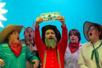 Students performing in Trail to Oregon holding a 1,000,000 dollar bill