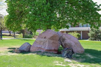 Large red rocks on a green lawn