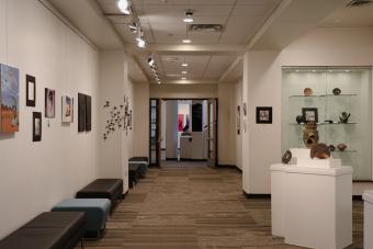 art on walls and a hallway leading to two doors