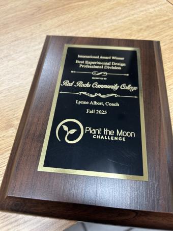 A wooden plaque from the Plant the Moon competition