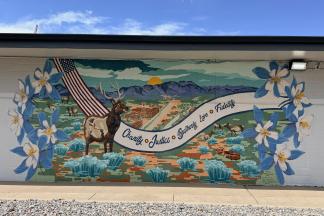 A mural with an elk, and columbine flowers.