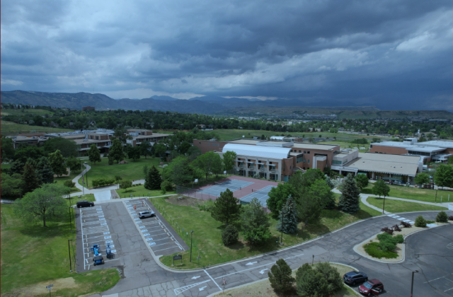 Overhead view of the RRCC Lakewood Campus with mountains in the background and storm clouds in the sky.  